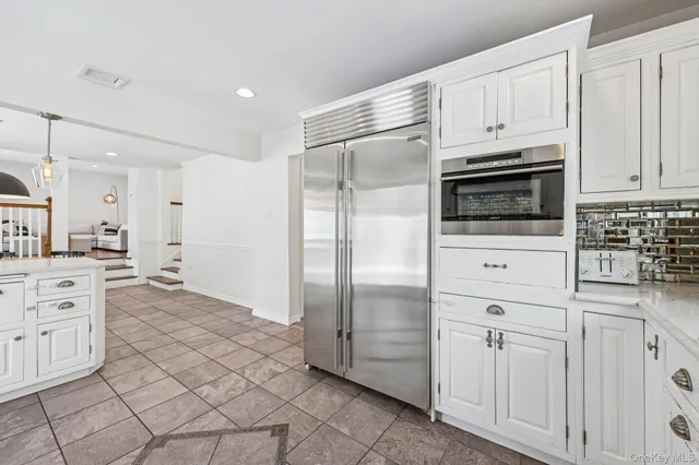 a kitchen with a stove top oven and cabinets