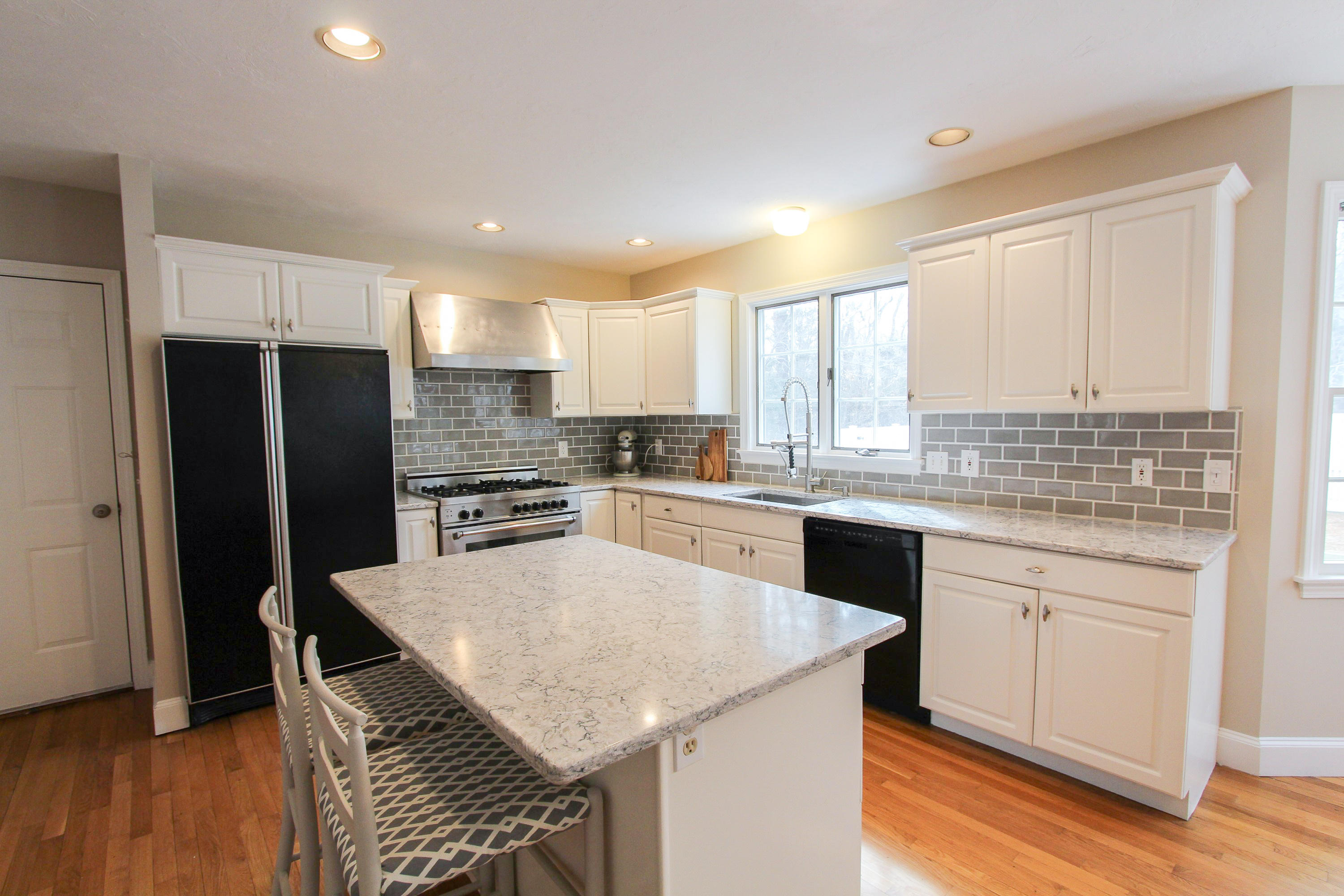 29 Schooner Drive Cotuit, MA 02635 - Photo 11 of 35 a kitchen with granite countertop stainless steel appliances a refrigerator sink and microwave