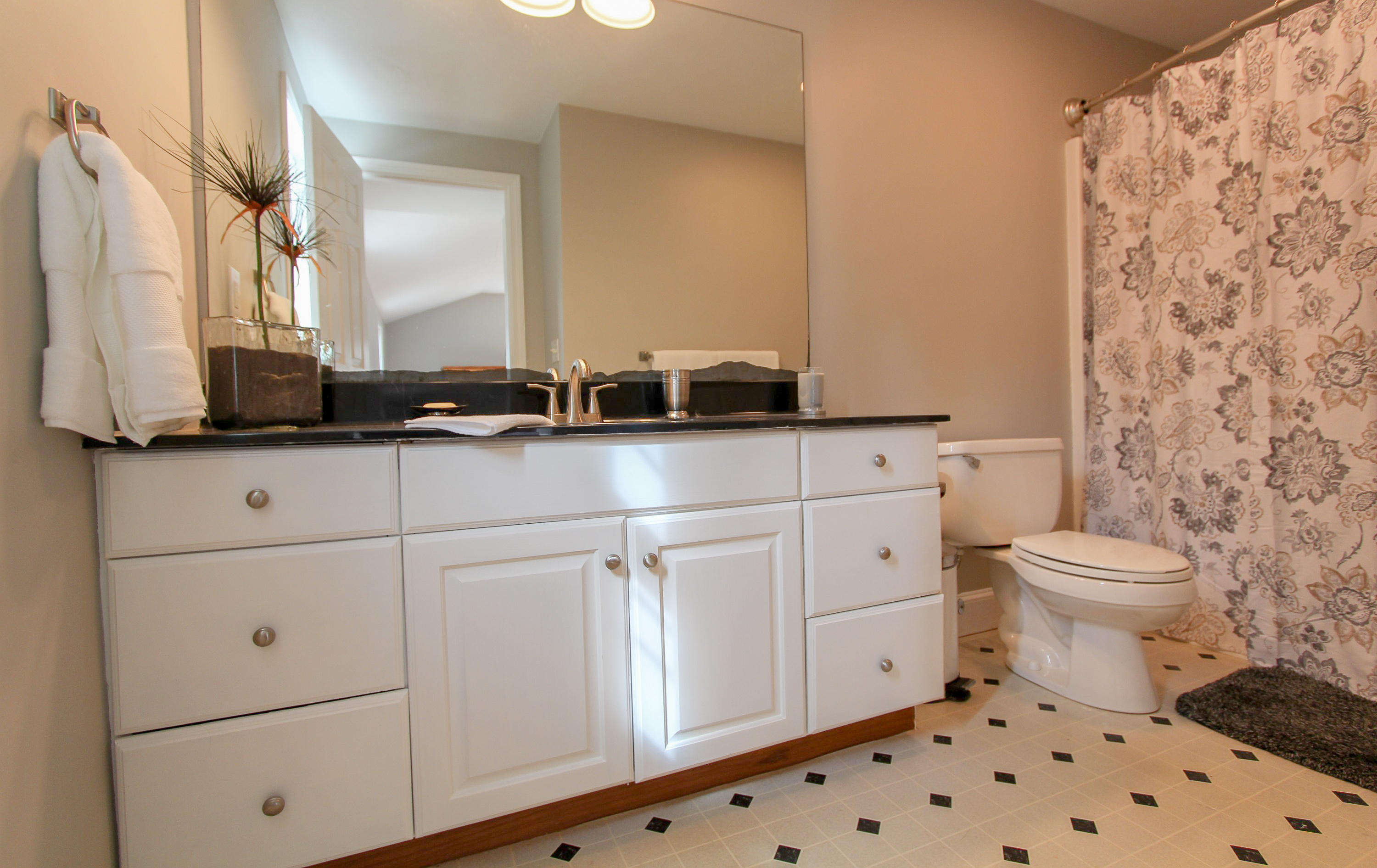 29 Schooner Drive Cotuit, MA 02635 - Photo 23 of 35 a bathroom with a sink a toilet and a mirror