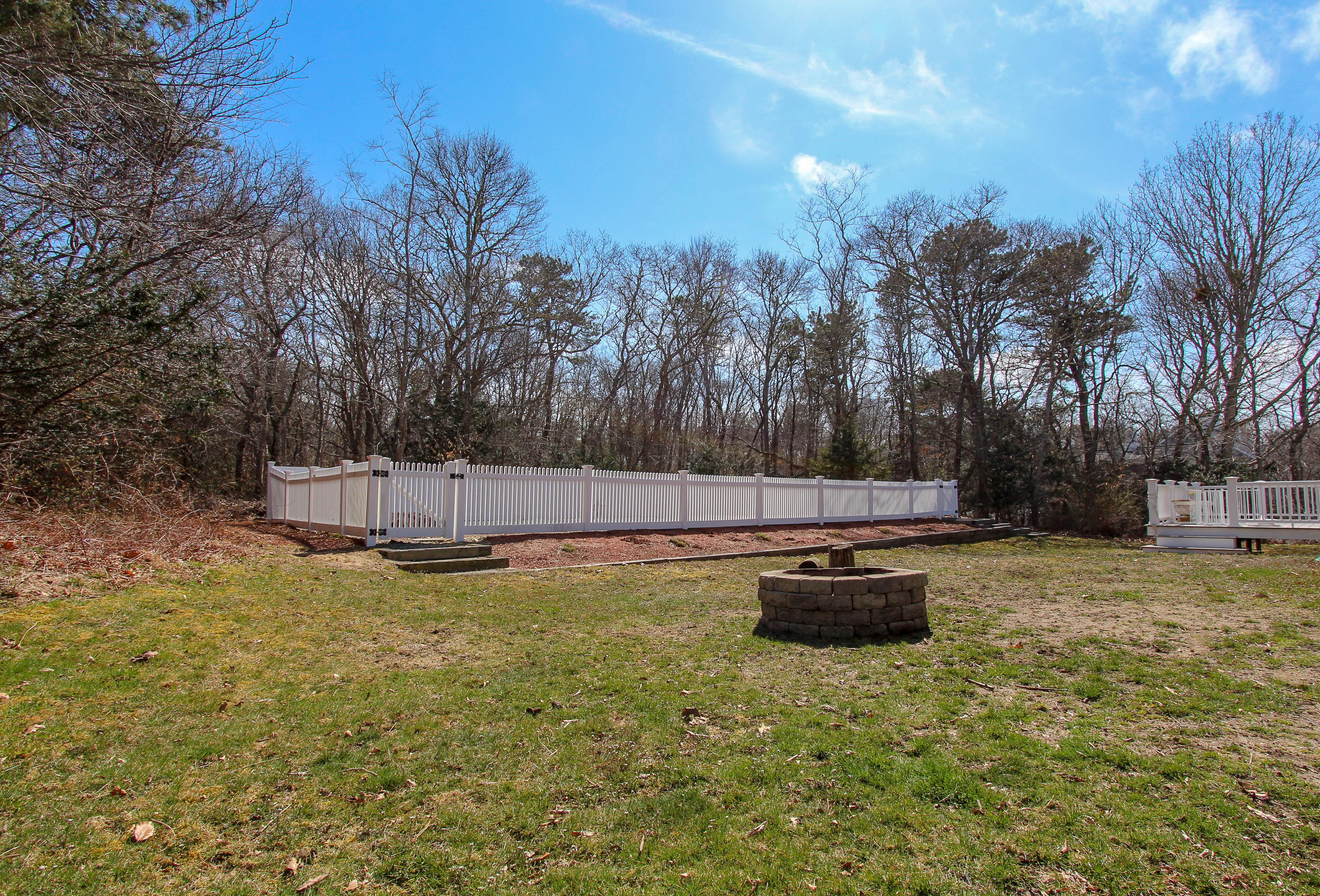29 Schooner Drive Cotuit, MA 02635 - Photo 29 of 35 a backyard of a house with lots of green space