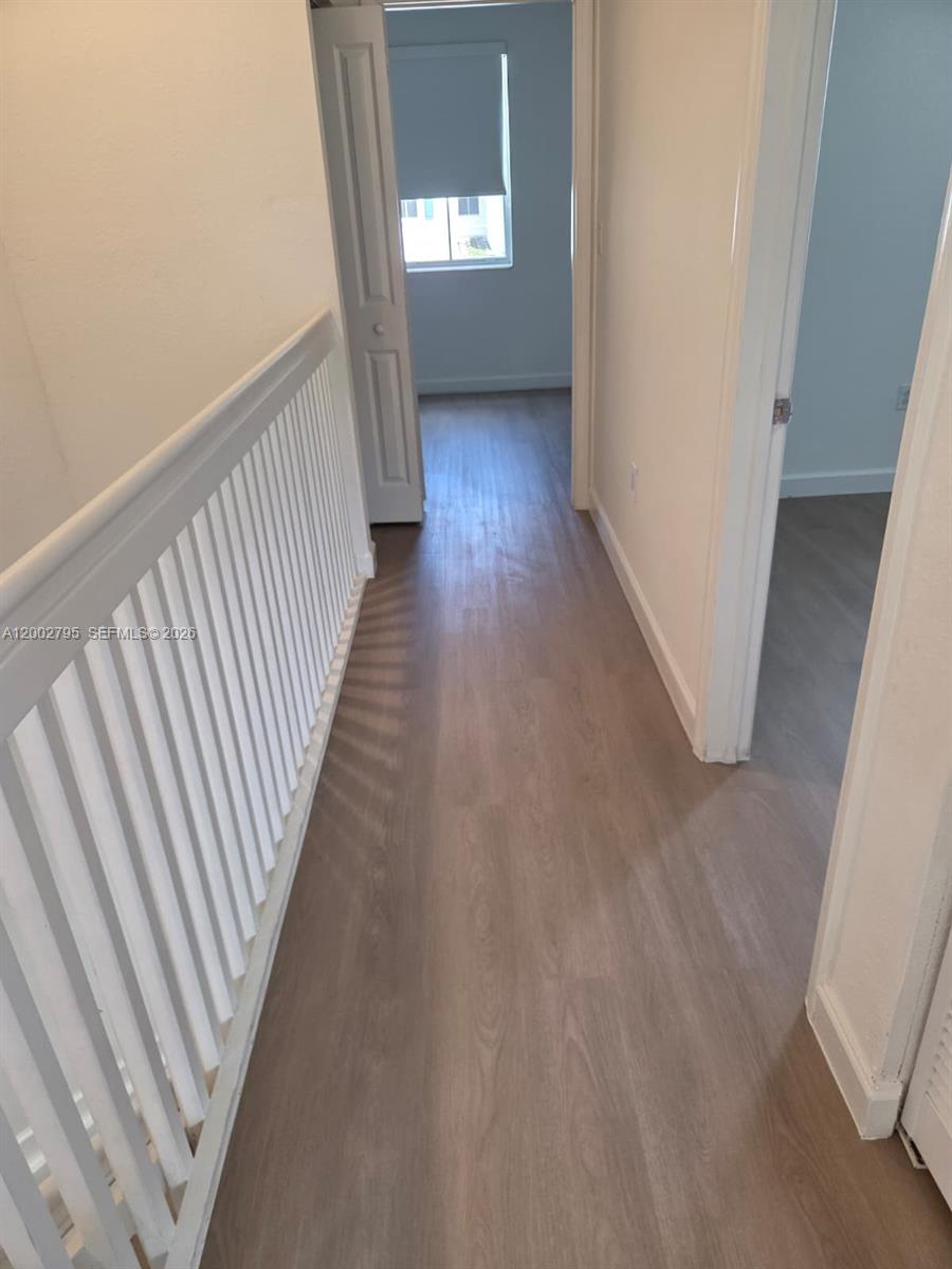1844 Southeast 27th Street Homestead, FL 33035 - Photo 11 of 23 a view of a hallway view with wooden floor and staircase