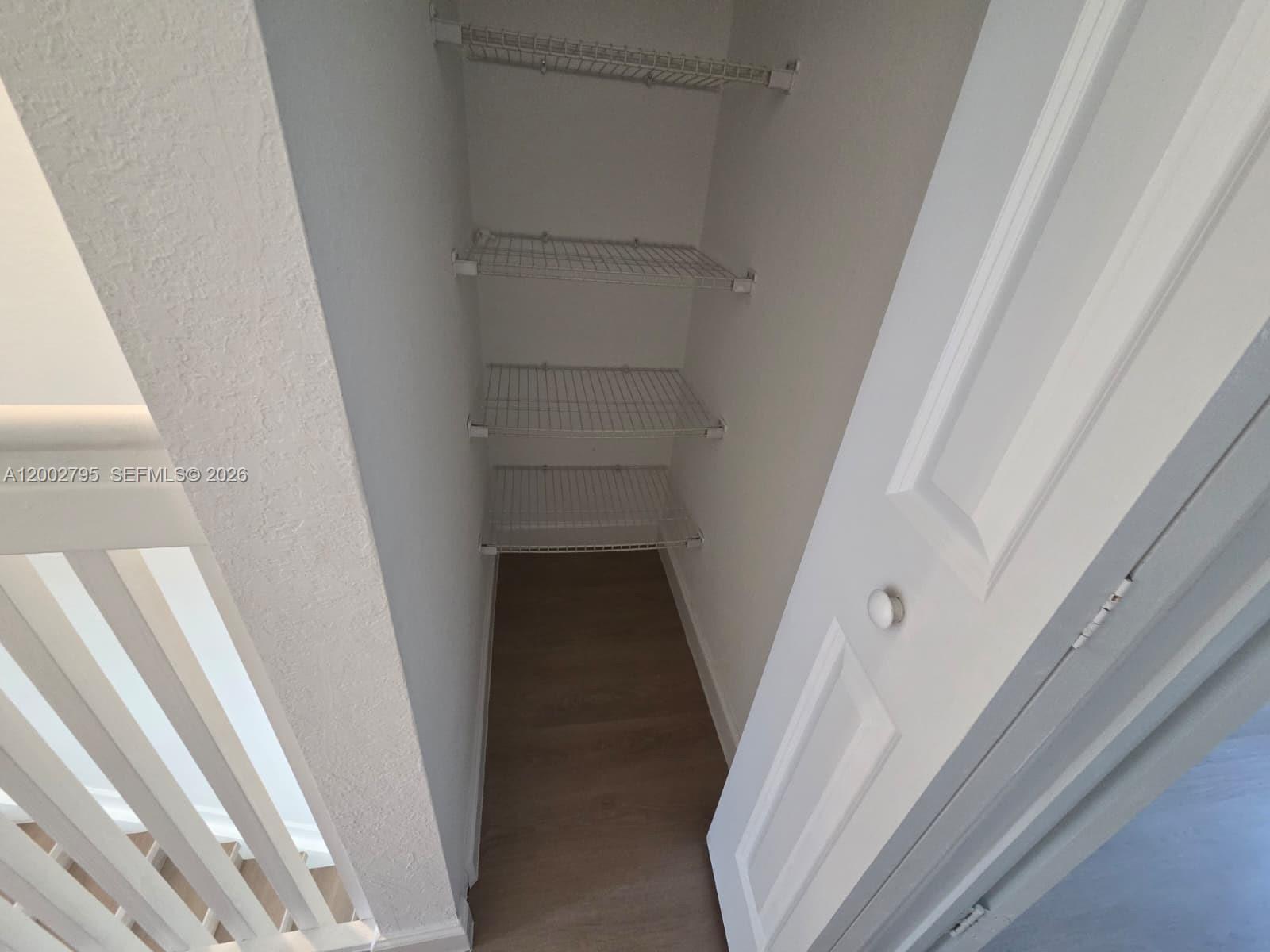 1844 Southeast 27th Street Homestead, FL 33035 - Photo 15 of 23 a view of staircase with white walls and railing