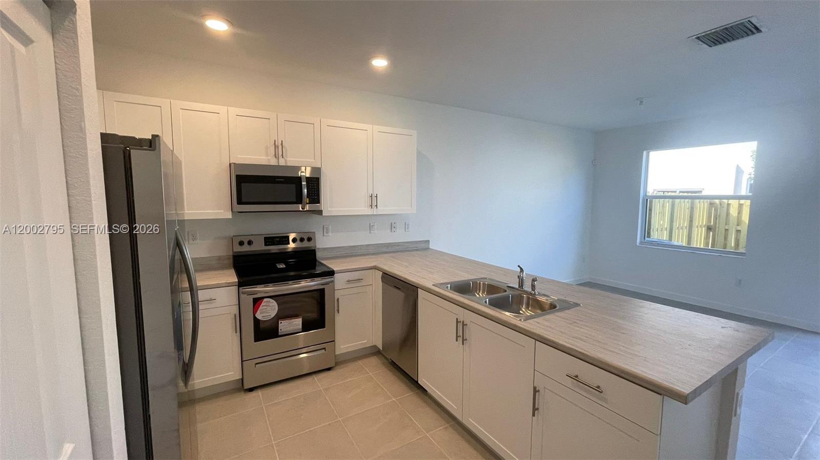 1844 Southeast 27th Street Homestead, FL 33035 - Photo 3 of 23 a kitchen with a sink appliances and cabinets