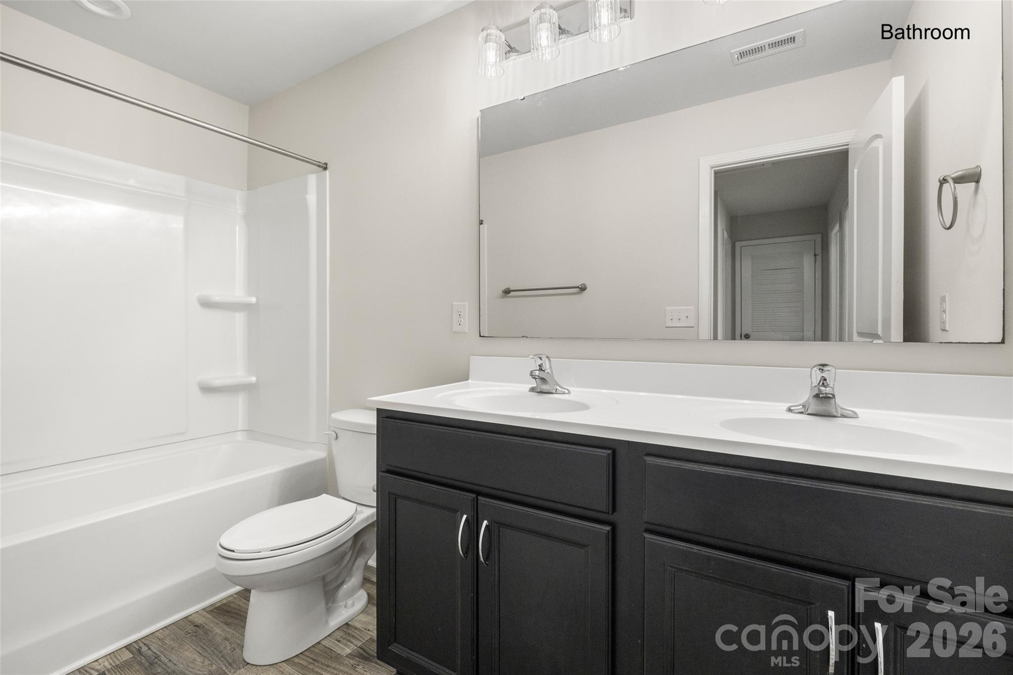 463 West Barr Street Lancaster, SC 29720 - Photo 15 of 43 a bathroom with a toilet a sink a mirror a bathtub and vanity