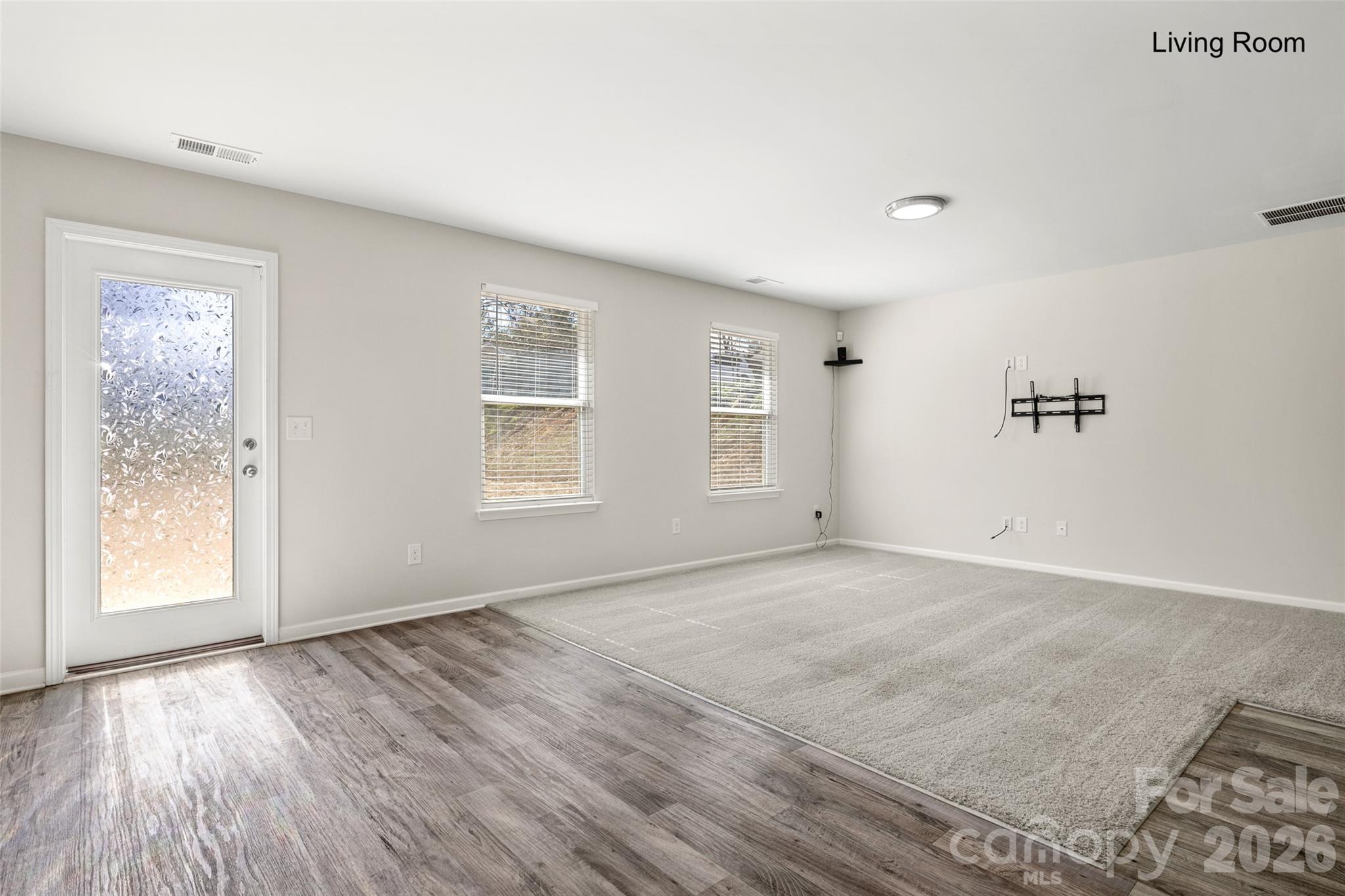 463 West Barr Street Lancaster, SC 29720 - Photo 3 of 43 an empty room with wooden floor and windows