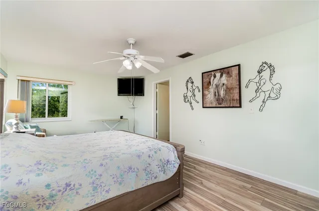 a bedroom with a large bed and a window