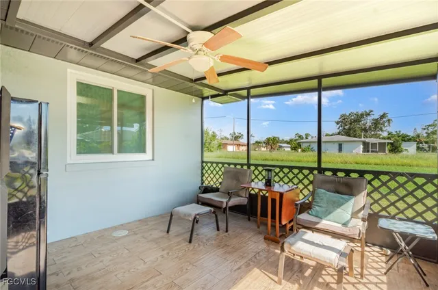 a balcony with furniture and a floor to ceiling window