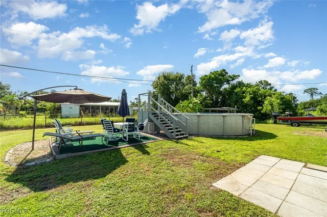 a view of a backyard with swimming pool