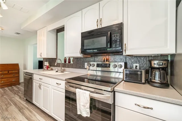 a kitchen with stainless steel appliances a stove and a microwave