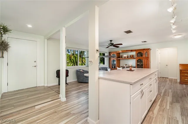 a kitchen with a sink and wooden floor