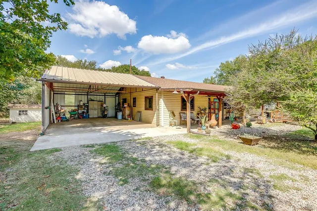 a view of a house with a yard and sitting area