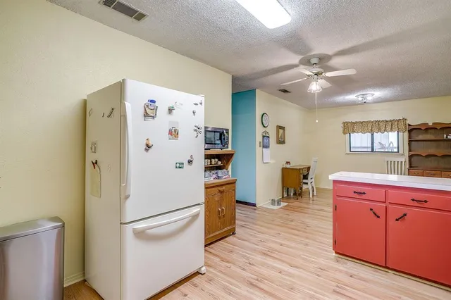 a white refrigerator freezer sitting inside of a kitchen
