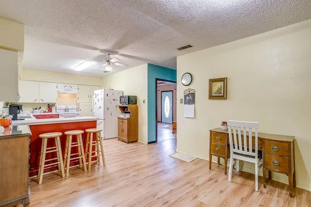 a dining room with furniture wooden floor and a rug