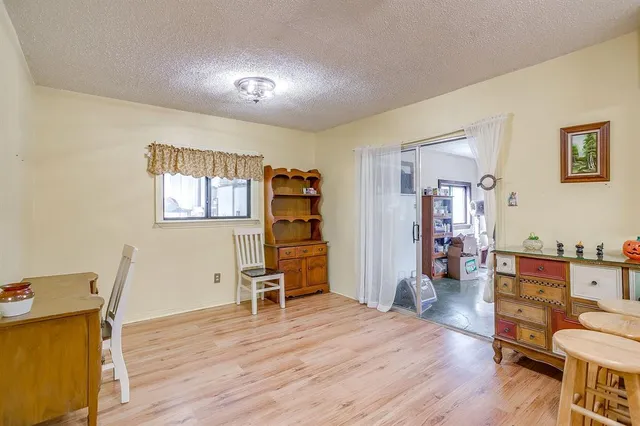 a view of a workspace with furniture and wooden floor