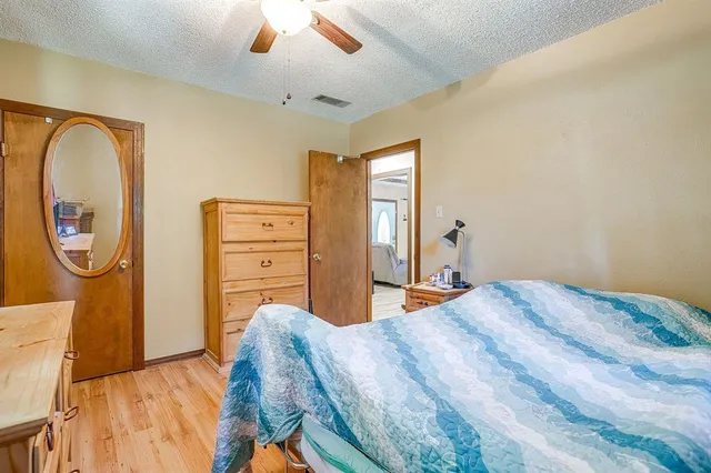 a bedroom with a bed and a dresser