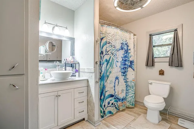 a bathroom with a toilet sink and mirror