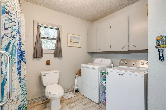 a view of bathroom with a toilet sink and mirror
