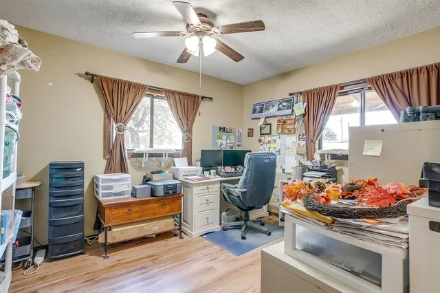 a living room with furniture a fireplace and a large window