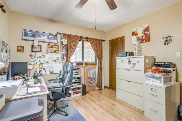 a room with a workspace and a window