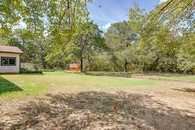 a view of a yard with swimming pool