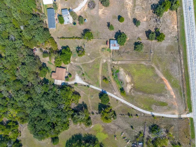 an aerial view of house with yard