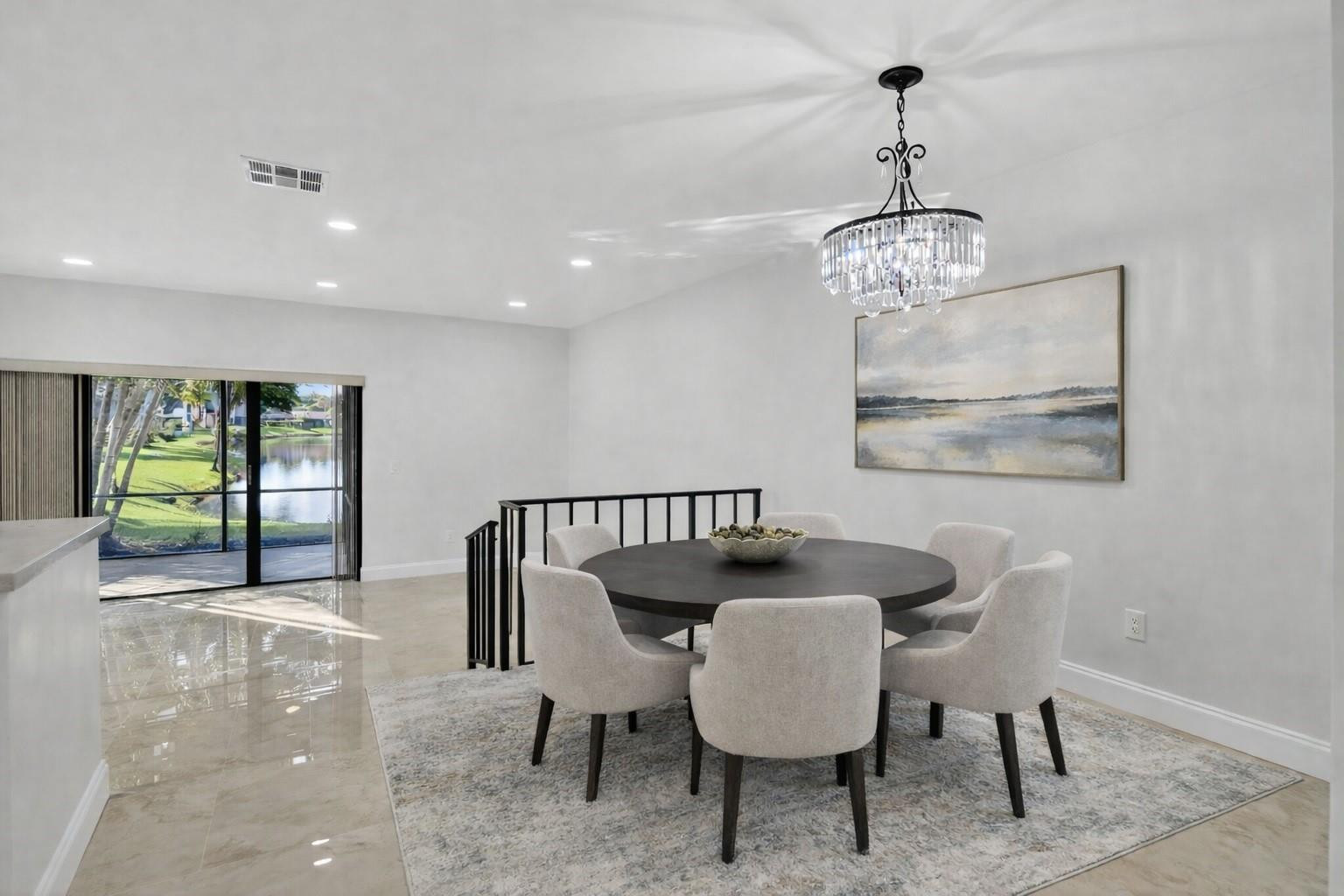 21476 Juego Circle, Unit 8C Boca Raton, FL 33433 - Photo 11 of 54 a view of a dining room with furniture wooden floor and chandelier