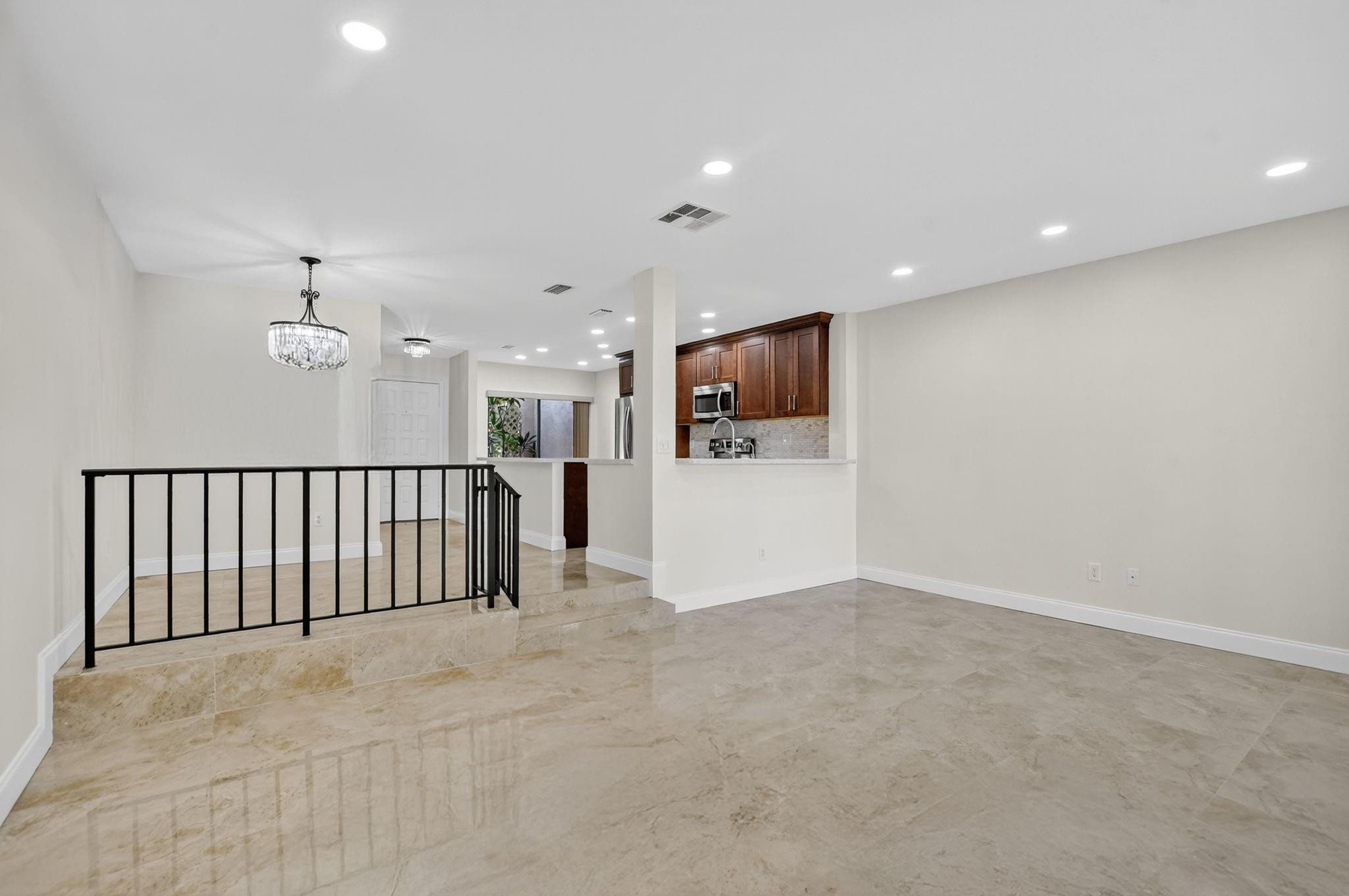 21476 Juego Circle, Unit 8C Boca Raton, FL 33433 - Photo 15 of 54 a view of a livingroom with furniture and a flat screen tv