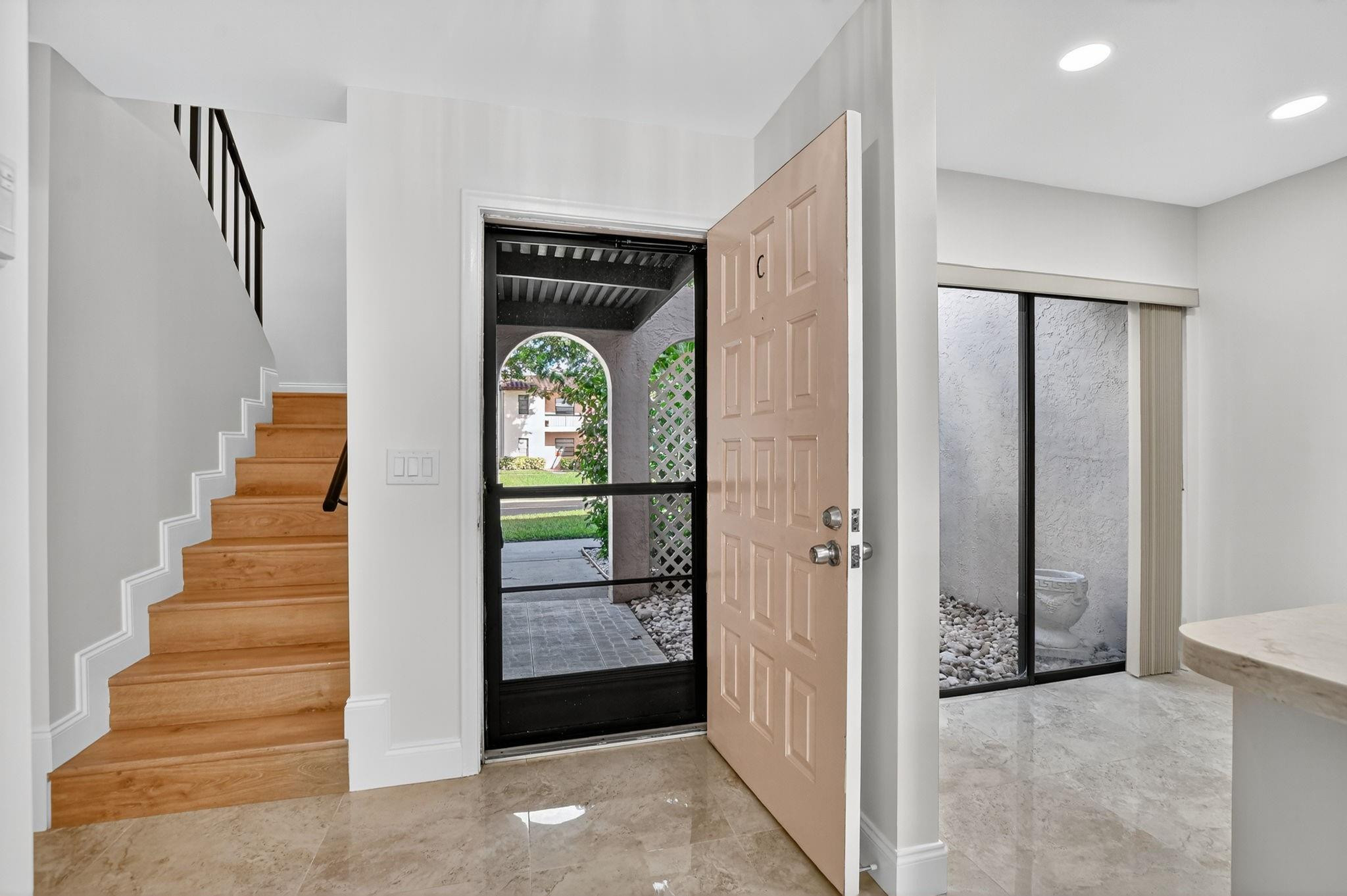 21476 Juego Circle, Unit 8C Boca Raton, FL 33433 - Photo 17 of 54 a view of entryway and hall with a front door