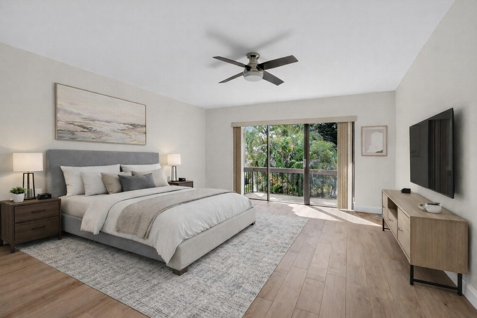 21476 Juego Circle, Unit 8C Boca Raton, FL 33433 - Photo 22 of 54 a bedroom with a large bed and a flat screen tv