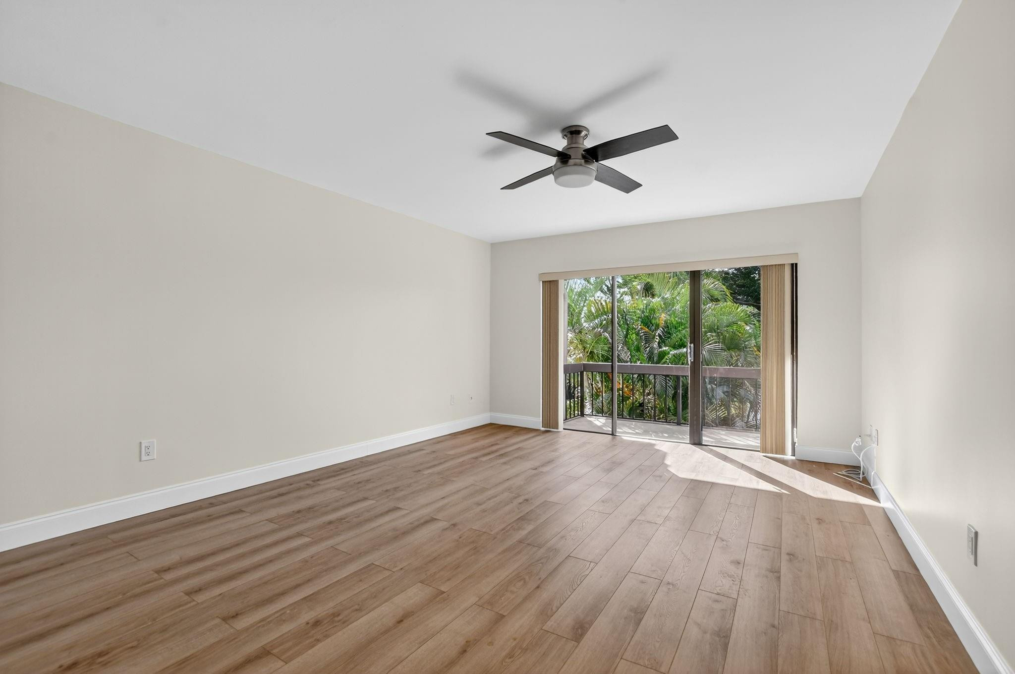 21476 Juego Circle, Unit 8C Boca Raton, FL 33433 - Photo 23 of 54 a view of room with wooden floor and windows