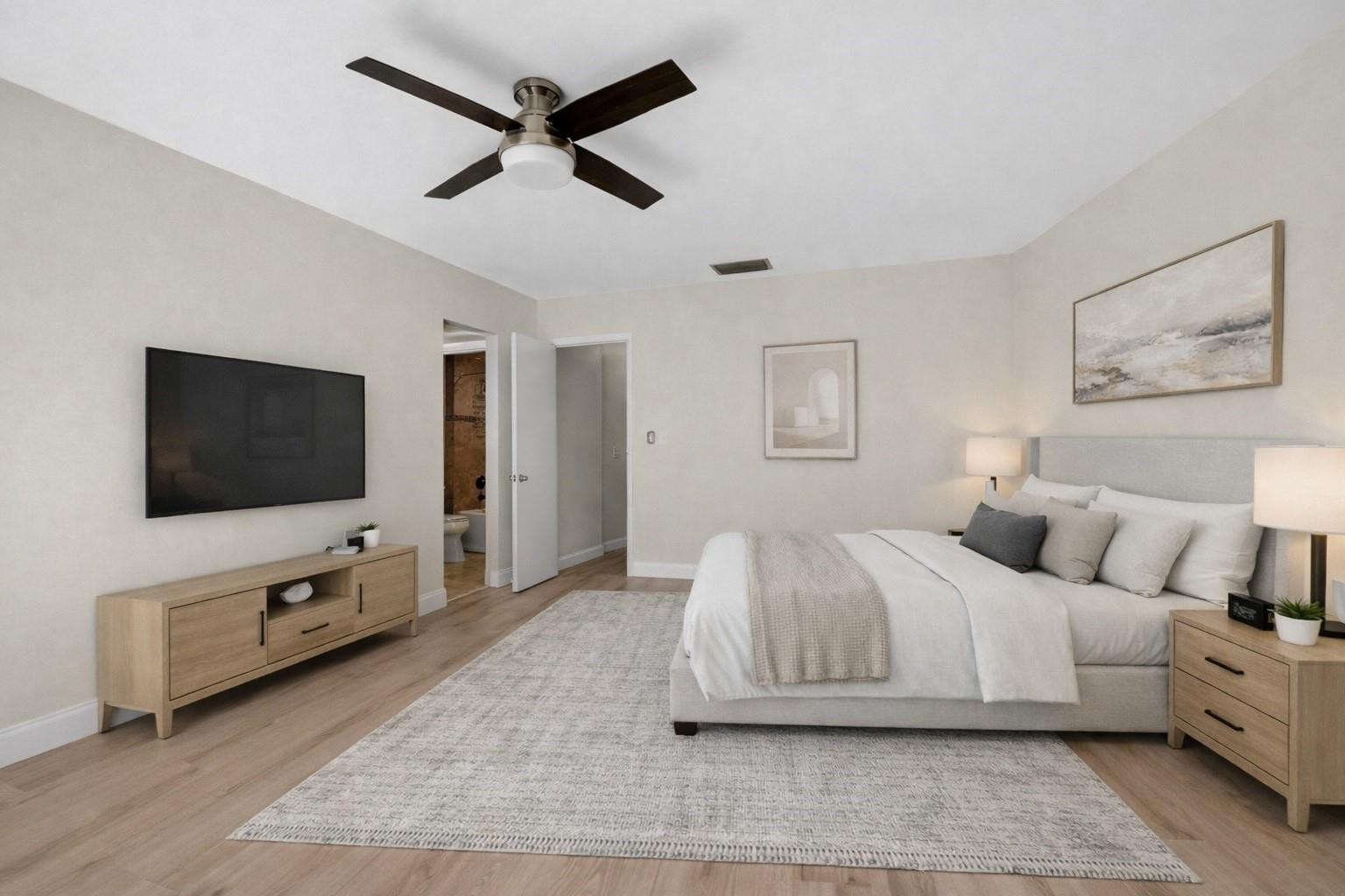 21476 Juego Circle, Unit 8C Boca Raton, FL 33433 - Photo 24 of 54 a bedroom with a bed and a flat screen tv