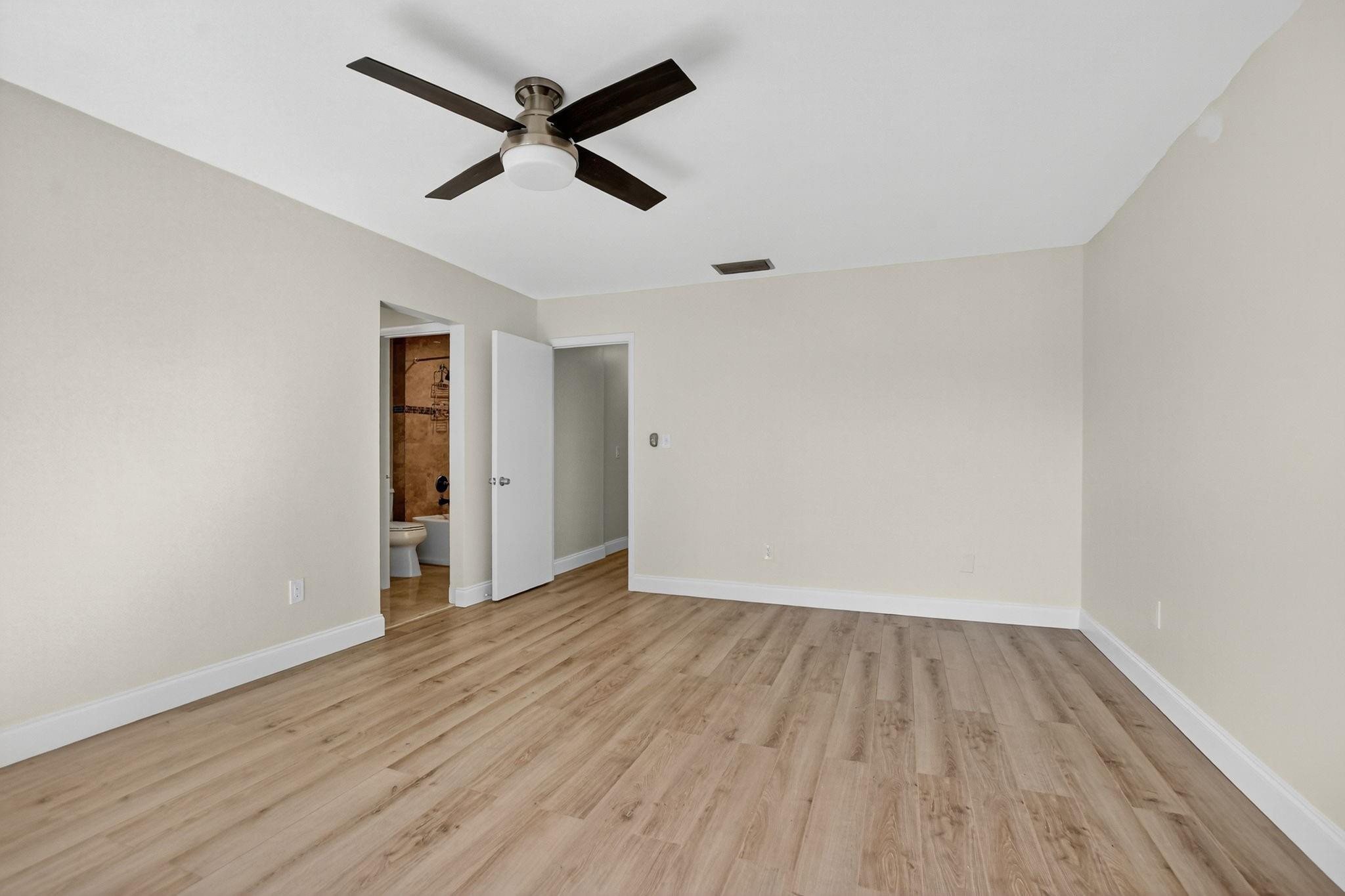 21476 Juego Circle, Unit 8C Boca Raton, FL 33433 - Photo 25 of 54 wooden floor in an empty room