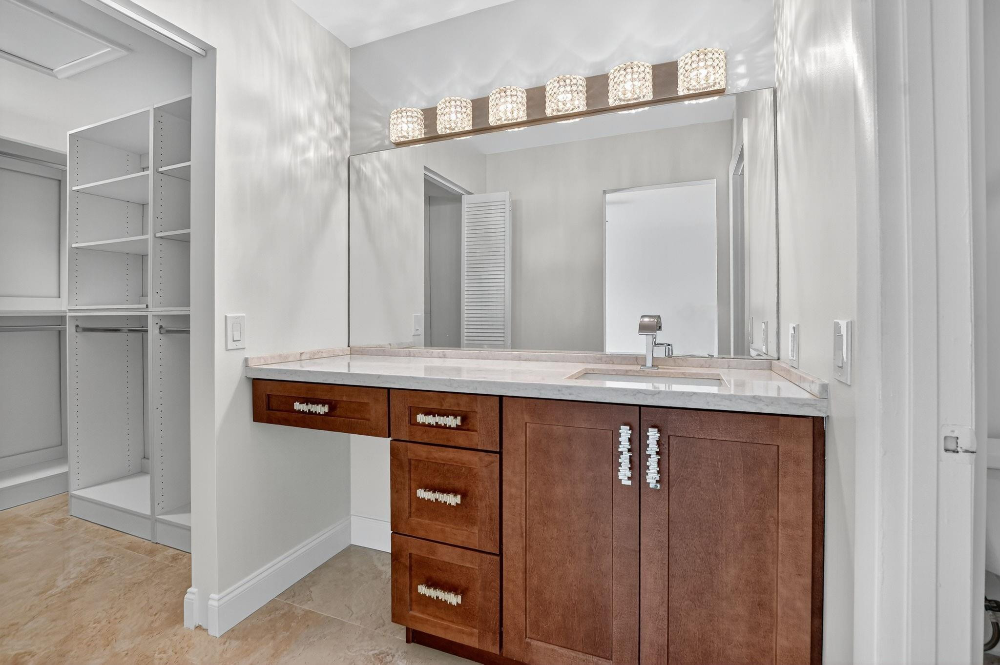 21476 Juego Circle, Unit 8C Boca Raton, FL 33433 - Photo 29 of 54 a bathroom with a sink and a mirror