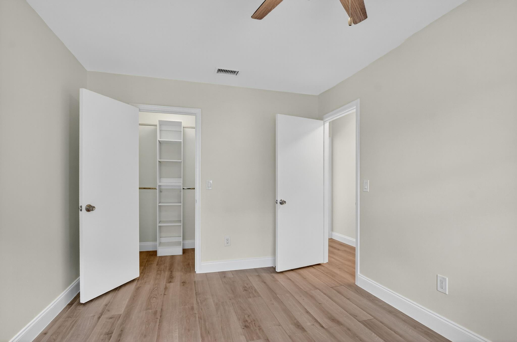 21476 Juego Circle, Unit 8C Boca Raton, FL 33433 - Photo 34 of 54 a view of an empty room with wooden floor