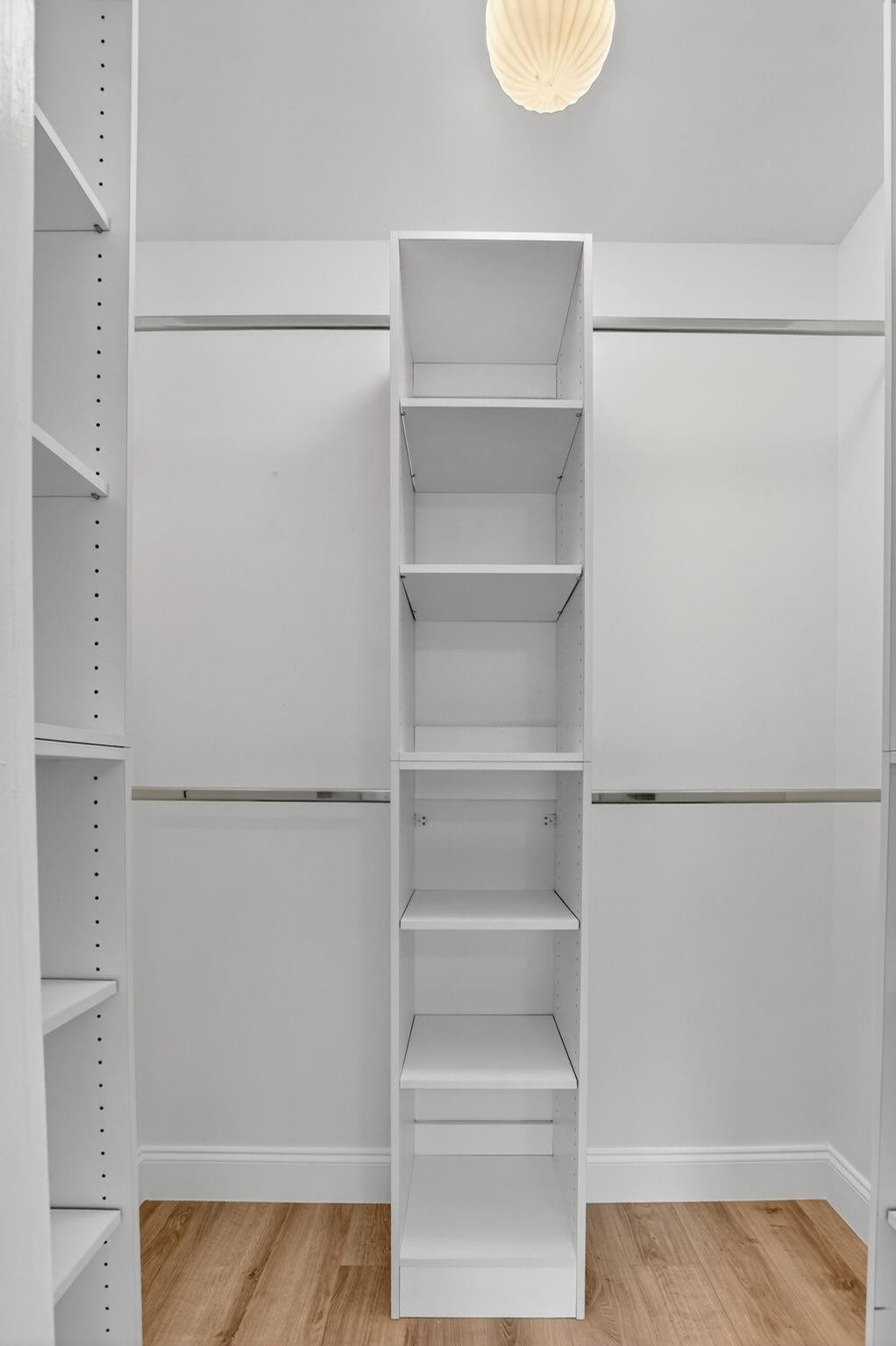 21476 Juego Circle, Unit 8C Boca Raton, FL 33433 - Photo 35 of 54 a white refrigerator freezer and a dishwasher with wooden floor