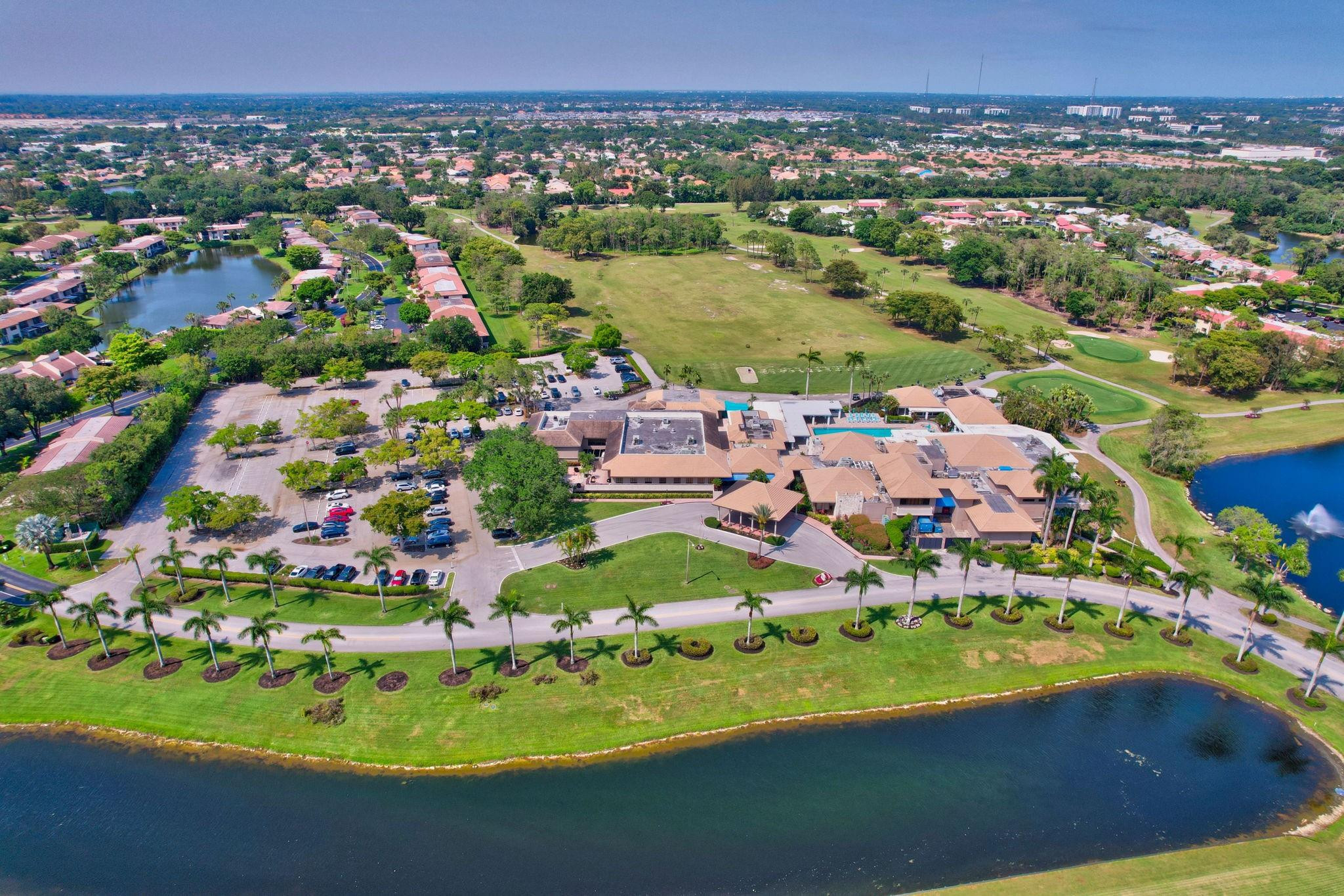 21476 Juego Circle, Unit 8C Boca Raton, FL 33433 - Photo 48 of 54 an aerial view of residential houses with outdoor space