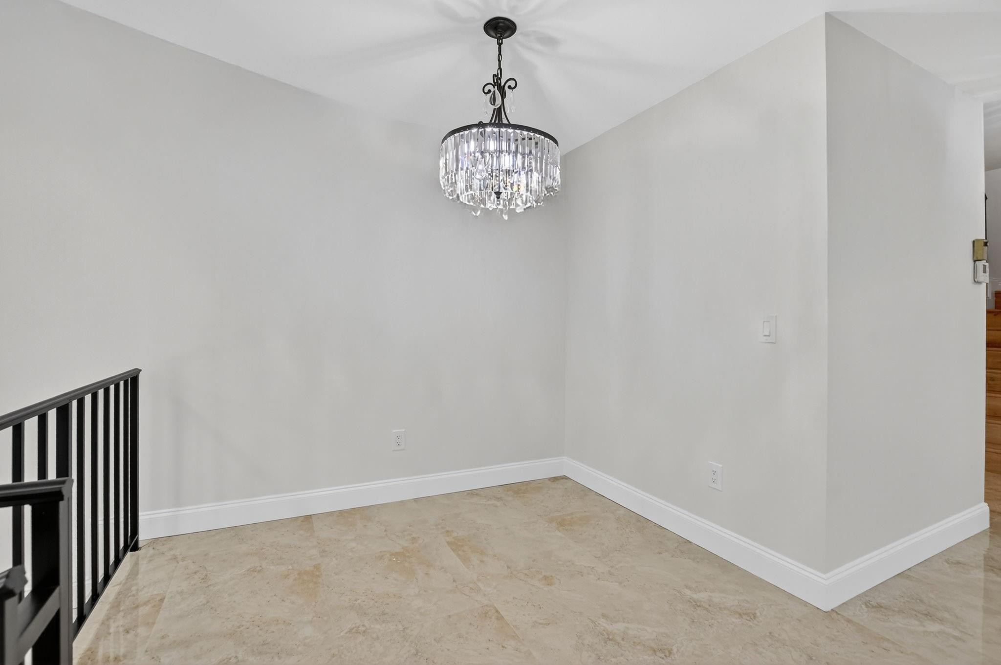 21476 Juego Circle, Unit 8C Boca Raton, FL 33433 - Photo 10 of 54 a view of an empty room with a chandelier fan