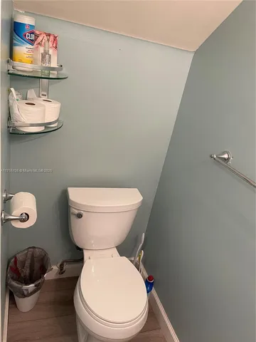 a white toilet sitting next to a bathroom sink