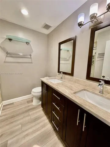 a bathroom with a double vanity sink and a mirror