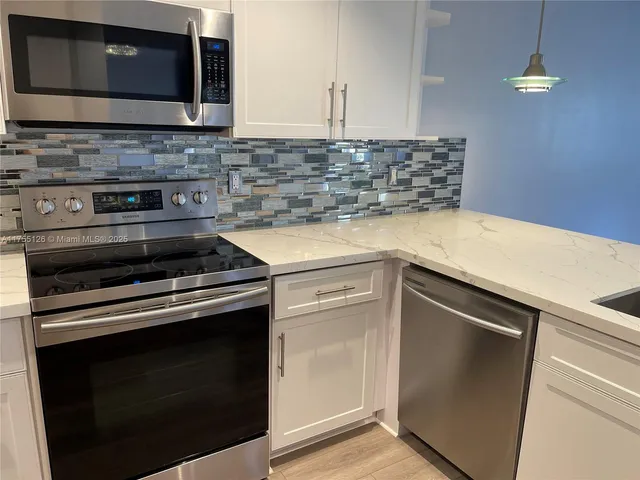 a kitchen with a stove and a microwave