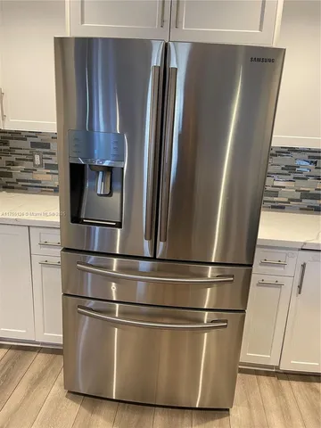 a refrigerator freezer sitting inside of a kitchen