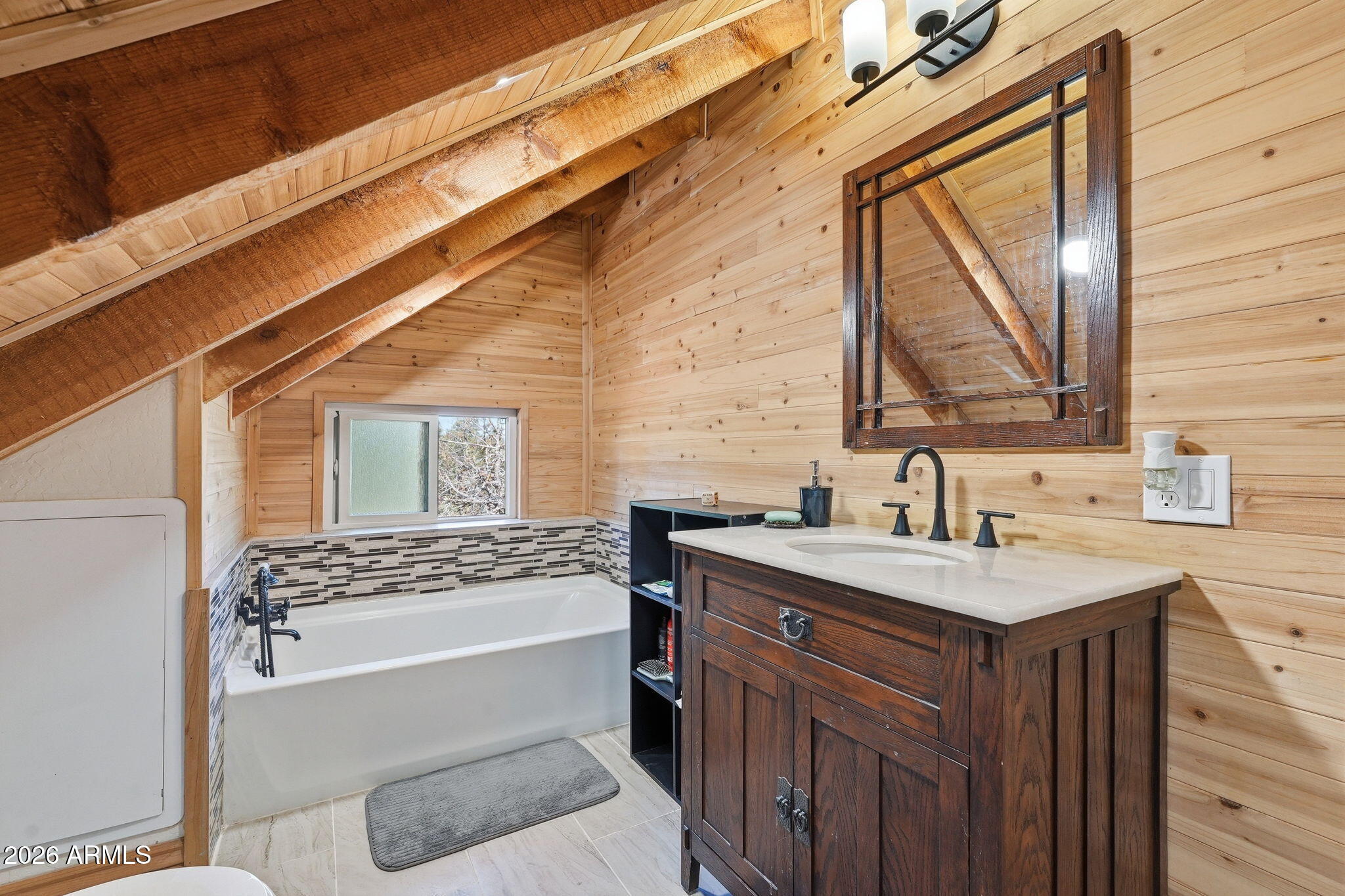 2060 Gilbert Lane Overgaard, AZ 85933 - Photo 50 of 87 a bathroom with a sink a mirror and a bathtub