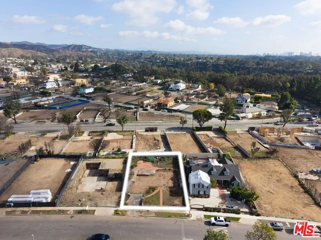 an aerial view of residential houses with city view