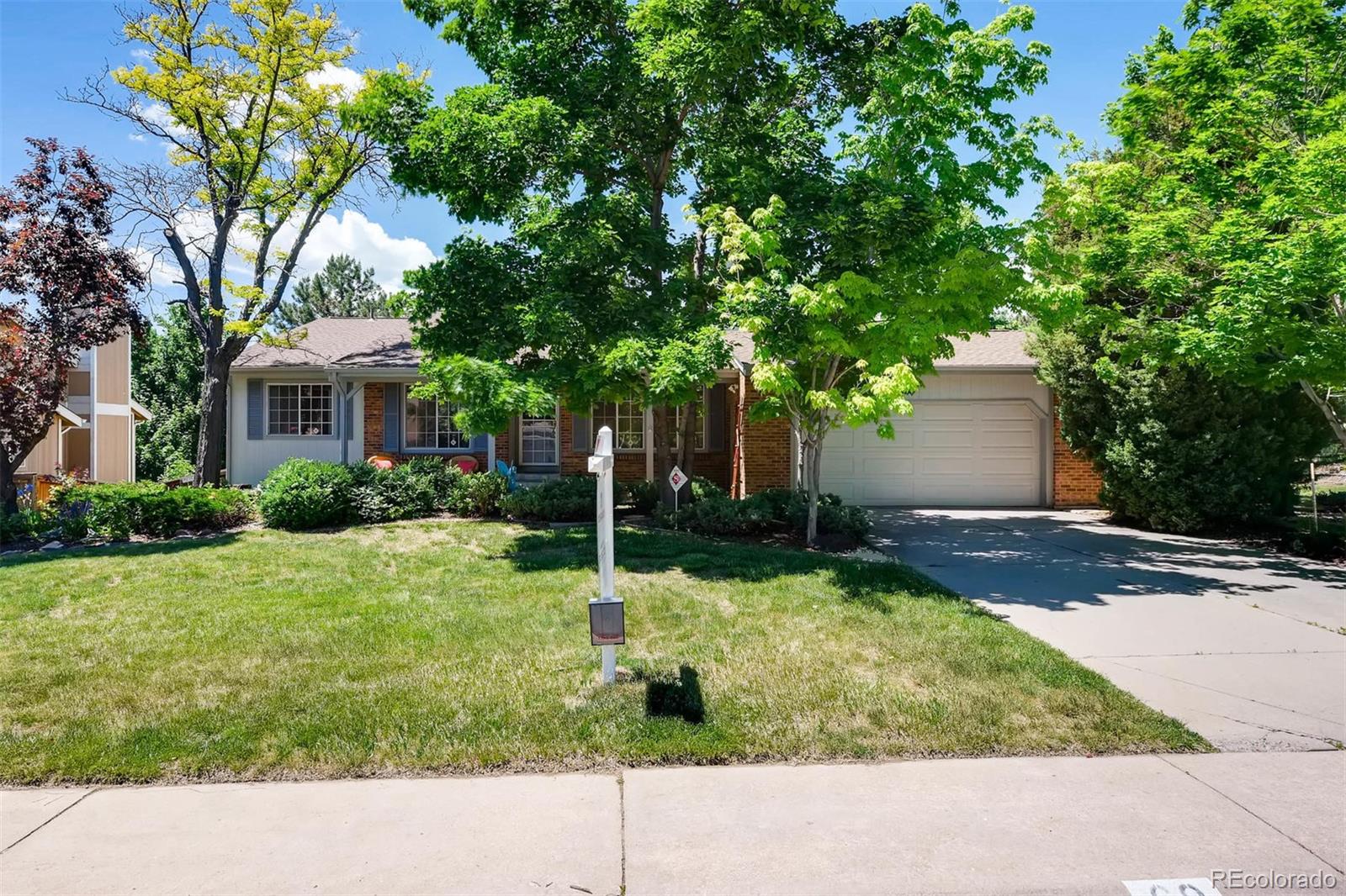69 Prairie Ridge Road Highlands Ranch, CO 80126 - Photo 1 of 28 a backyard of a house with yard and garage