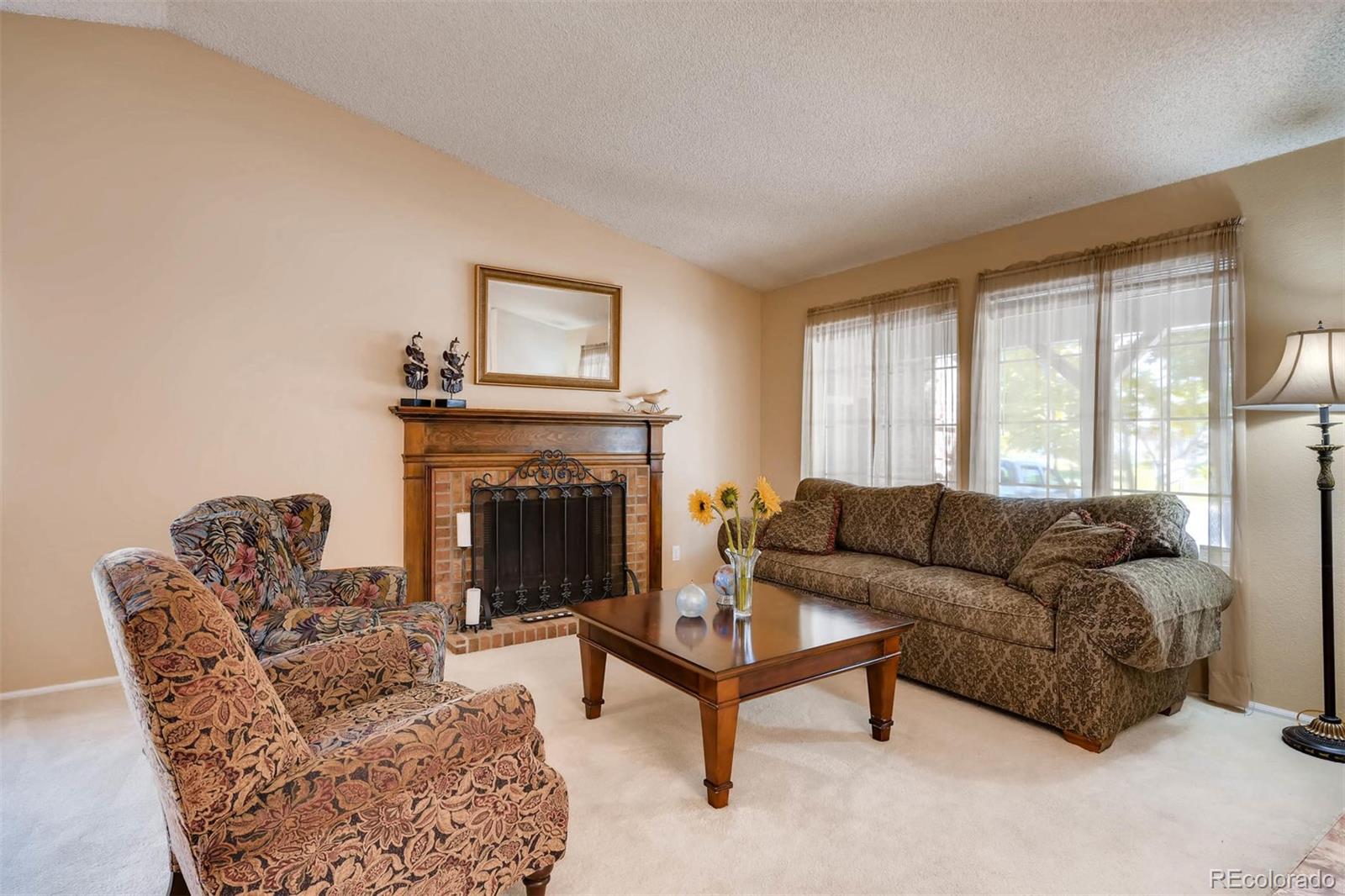 69 Prairie Ridge Road Highlands Ranch, CO 80126 - Photo 3 of 28 a living room with furniture and a fireplace