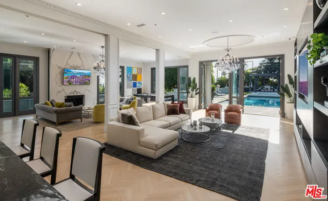a living room with furniture and a book shelf