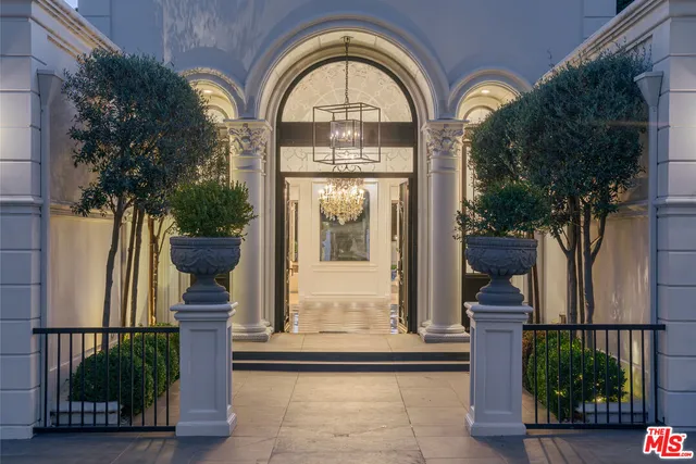 a view of a patio with table and chairs potted plants and floor to ceiling window