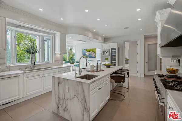 a kitchen with a sink and a large window