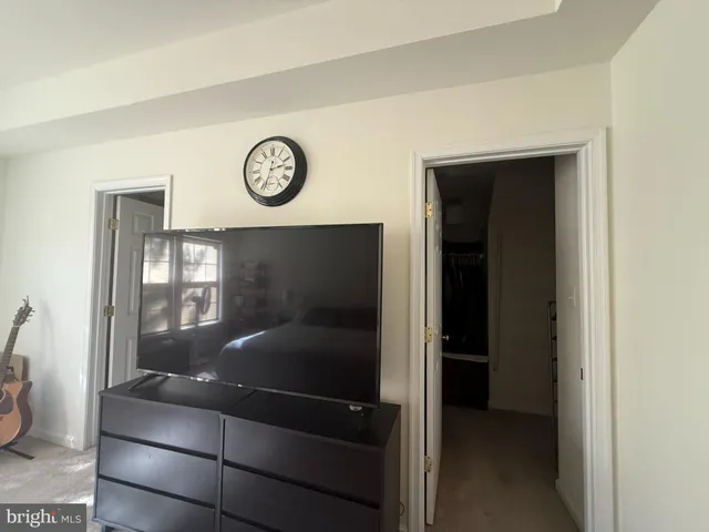 a room with a walk in closet and a chair