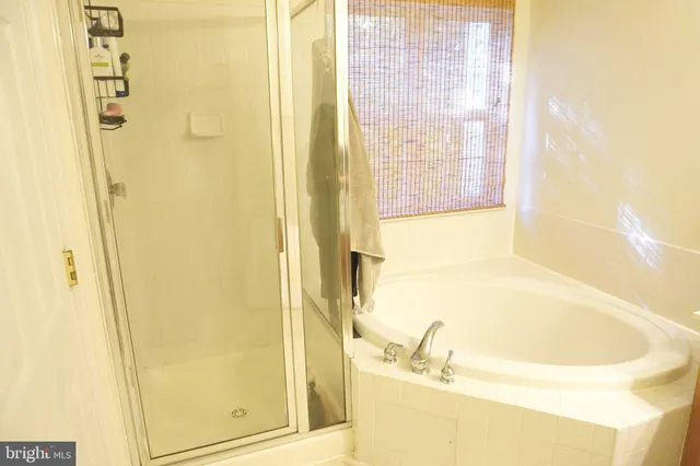 a bathroom with a tub and shower